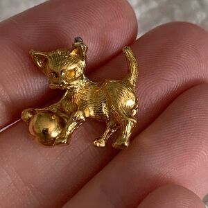 Broken gold cat charm